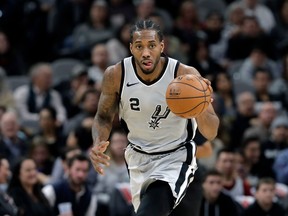 In this Jan. 13, 2018 file photo, San Antonio Spurs forward Kawhi Leonard moves the ball up court against the Denver Nuggets.
