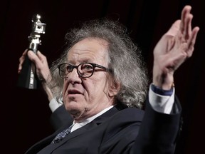 FILE - In this Feb. 11, 2017, file photo, Australian actor Geoffrey Rush poses with his Berlinale Camera Award which he received prior to the screening of the film "Final Portrait" at the 2017 Berlinale Film Festival in Berlin, Germany. Rush has pulled out of a Shakespeare stage production in the Australian city of Melbourne as he sues a Sydney newspaper for defamation.