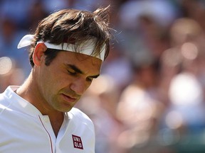 Roger Federer reacts during his semifinal match against Kevin Anderson at Wimbledon on July 11.
