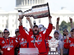 FILE - In this Tuesday, June 12, 2018 file photo Washington Capitals Alex Ovechkin, from Russia, holds up the Stanley Cup trophy during the NHL hockey team's Stanley Cup victory celebration, at the National Mall in Washington. Alex Ovechkin is bringing the Stanley Cup to the World Cup. Fresh off winning the NHL title, the Washington Capitals forward is taking the trophy to Moscow on Saturday, where it will be exhibited at a "fan fest" public viewing site ahead of Russia's quarterfinal game against Croatia.