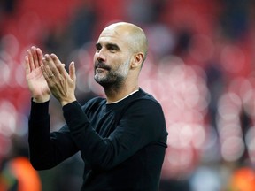 FILE - In this file photo dated Saturday, April 14, 2018, Manchester City manager Pep Guardiola applauds the fans as he walks from the pitch after the end of the English Premier League soccer match against Tottenham Hotspur at Wembley stadium in London. The World Cup triumphs of Spain and Germany in 2010 and '14, respectively, were partly put down to the influence of Pep Guardiola on the club sides _ Barcelona and Bayern Munich _ which made up a significant chunk of those national teams. Could Guardiola be having the same effect on England, too?