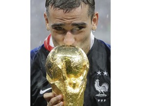 France's Antoine Griezmann kisses the trophy after the final match between France and Croatia at the 2018 soccer World Cup in the Luzhniki Stadium in Moscow, Russia, Sunday, July 15, 2018. France won the final 4-2.