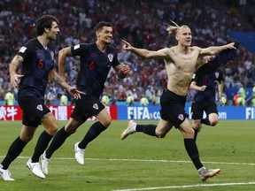 Croatia's Domagoj Vida, right, celebrates with his teammates after scoring his side's second goalduring the quarterfinal match between Russia and Croatia at the 2018 soccer World Cup in the Fisht Stadium, in Sochi, Russia, Saturday, July 7, 2018.