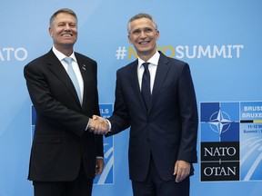 Romanian President Klaus Werner Iohannis, left, is greeted by NATO Secretary General Jens Stoltenberg before a summit of heads of state and government at NATO headquarters in Brussels on Wednesday, July 11, 2018. NATO leaders gather in Brussels for a two-day summit to discuss Russia, Iraq and their mission in Afghanistan.