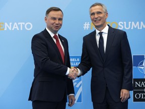 Poland's President Andrzej Duda is greeted by NATO Secretary General Jens Stoltenberg before a summit of heads of state and government at NATO headquarters in Brussels on Wednesday, July 11, 2018.