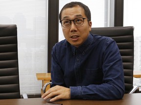 FILE - In this March 2, 2017, file photo, Yusuke Umeda, the co-chief executive of Tokyo-based startup Uzabase, speaks during an interview in Tokyo. Japanese media startup Uzabase is acquiring Quartz, a New York-based online business news platform, from Atlantic Media.