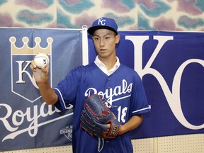 CORRECTS DATE - In this July 8, 2018 photo, Kaito Yuki poses for photographers at a press conference in Osaka, western Japan. Yuki is headed to the Kansas City Royals organization instead of attending high school in Japan. The team signed Yuki, a 16-year-old pitcher, out of junior high to a standard seven-year minor league contract Sunday. He is thought to be the first Japanese junior high school player to sign with a major league club.