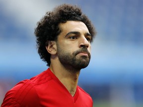 FILE - In this file photo dated Monday, June 18, 2018, Egypt's Mohamed Salah practices during Egypt's official training on the eve of the group A match between Russia and Egypt at the 2018 soccer World Cup,  in St. Petersburg, Russia.  Salah, the Premier League's top scorer, greeted adoring crowds who turned up at his door after his Cairo address was leaked on Facebook.  According to media reports, the Liverpool star showed no sign of anger as he received fans, posing for photos and signing autographs shortly after his arrival along with Egypt's national team from Russia following a disappointing World Cup showing.