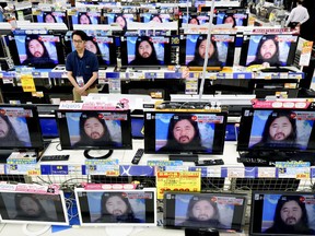 TV screens at an electrical appliance store show the image of doomsday cult leader Shoko Asahara in news reports, in Urayasu, near Tokyo, Friday, July 6, 2018. Asahara and six followers were executed Friday for their roles in a deadly 1995 gas attack on the Tokyo subways and other crimes, Japan's Justice Ministry said. (Kyodo News via AP)