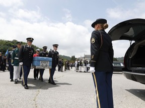 Honor guards of South Korea and the United Nations Command (UNC) carry boxes containing the remains of two servicemen killed during the 1950-53 Korean War, during a mutual repatriation ceremony at Seoul National Cemetery in Seoul, South Korea, Friday, July 13, 2018. The United States and South Korea held the ceremony to return home the remains of two servicemen - an unidentified allied soldier, presumably American, and a South Korean soldier.