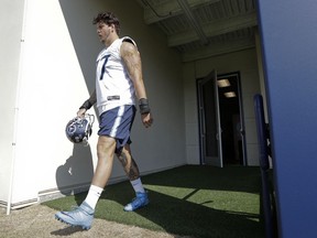Tennessee Titans offensive tackle Taylor Lewan walks onto the field for the first day of NFL football training camp Thursday, July 26, 2018, in Nashville, Tenn.
