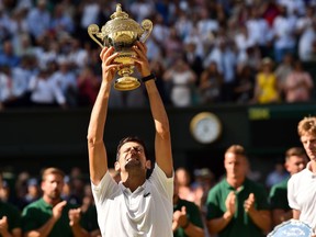 Novak Djokovic lifts the winner's trophy after beating Kevin Anderson in the Wimbledon men's final on July 15.
