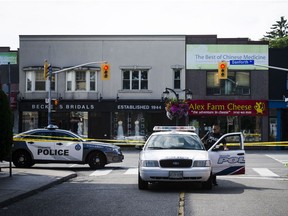 Police are shown at the perimeter of the scene of a shooting in east Toronto, on Monday, July 23, 2018. Police were trying Monday to determine what prompted a 29-year-old man to go on a shooting rampage in a popular Toronto neighbourhood, killing two people and injuring 12 others.