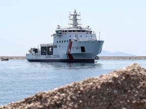 The Diciotti ship of the Italian Coast Guard, with 67 migrants on board rescued 4 days ago by the Vos Thalassa freighter, enters the Sicilian port of Trapani, southern Italy, Thursday, July 12, 2018. The top security officials of Germany, Italy and Austria are touting their hard line on migration issues, saying Europe needs to protect its exterior borders and crack down on human smuggling.