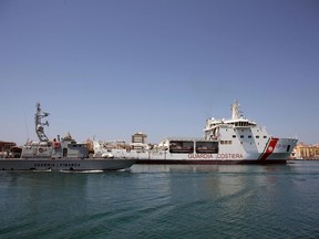 The Diciotti ship of the Italian Coast Guard, with 67 migrants on board rescued 4 days ago by the Vos Thalassa freighter, enters the Sicilian port of Trapani, southern Italy, Thursday, July 12, 2018. The top security officials of Germany, Italy and Austria are touting their hard line on migration issues, saying Europe needs to protect its exterior borders and crack down on human smuggling.