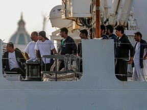 The Diciotti ship of the Italian Coast Guard, with 67 migrants on board rescued 4 days ago by the Vos Thalassa freighter, is moored in the Sicilian port of Trapani, southern Italy, Thursday, July 12, 2018. An Italian coast guard ship has docked in Sicily but is still awaiting permission to disembark its 67 migrants, after two of them were accused of threatening their rescuers if they were taken back to Libya. Interior Minister Matteo Salvini said Thursday he won't let the migrants off until there is clarity over what happened after an Italian commercial tugboat rescued them over the weekend. Italy's transport minister said some migrants made death threats against the crew. The threats prompted the Italian coast guard to board the migrants and bring them to Trapani.