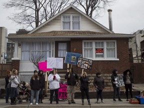 A group including family and friends protests in front of 19 McMillian Drive in Oshawa where police found the remains of 18-year-old Rori Hache in December, Friday, March 30, 2018.