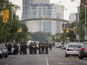 Police line the street at the scene where a gunman shot more than a dozen people on Danforth Avenue in Toronto, Ontario, July 23, 2018.