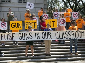 FILE - In this Oct. 1, 2015, file photo, protesters gather on the West Mall of the University of Texas campus, in Austin, to oppose a new state law that expands the rights of concealed handgun license holders to carry their weapons on public college campuses and as of Aug. 1, 2016, they can carry in campus buildings. Attorneys for three University of Texas professors were set to ask a federal appeals court Wednesday, July 11, 2018, to revive their lawsuit against the law allowing people with concealed-handgun licenses to carry weapons on public campuses.