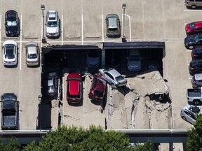 Emergency crews respond to a collapsed parking garage in Irving, Texas, Tuesday, July 31, 2018. A portion of a suburban Dallas parking garage has collapsed, sending vehicles and rubble onto others below, but authorities say there are no apparent injuries.