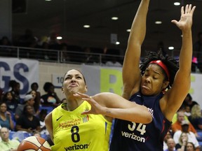 Dallas Wings center Liz Cambage (8) drives to the basket past the defense of Washington Mystics center Krystal Thomas (34) during the first half of a WNBA basketball game Thursday, July 19, 2018, in Arlington, Texas.