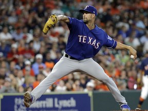 Texas Rangers starting pitcher Mike Minor throws against the Houston Astros during the first inning of a baseball game Sunday, July 29, 2018, in Houston.