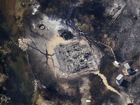 In this aerial photo, a burnt out structure is visible through the smoke as a wildfire continues to burn east of Strawberry Reservoir, in Wasatch County, Utah, Tuesday, July 3, 2018. The Utah fire comes as hot, dry conditions are fueling blazes in several Western states, including in Colorado and California.