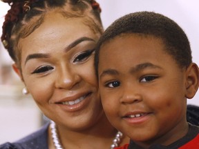 In this Friday, June 22, 2018, photo, Brianna Morgan poses with her son Harlem at their home in Petersburg, Va. Morgan, a single mother, hasn't had a license in three years because she owes more than $400 in traffic fines and court costs from traffic violations and a disorderly conduct citation.
