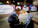 A young man attends a vigil remembering the victims of a shooting on Sunday evening on Danforth, Avenue in Toronto on Monday, July 23, 2018.
