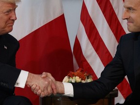 FILE - In this Thursday, May 25, 2017 file photo, U.S. President Donald Trump shakes hands with French President Emmanuel Macron during a meeting at the U.S. Embassy in Brussels. When Trump walks into a NATO summit Wednesday, July 11, 2018,  international politics are bound to become intensely personal _ again.