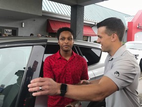 Alabama college student Walter Carr, left, is given keys to a car by Bellhops CEO Luke Marklin in Pelham, Ala., Monday, July 16, 2018.