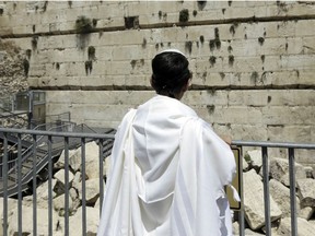 A boy overlooks the ancient Jerusalem's Western Wall, deemed the holiest site where Jews can pray.