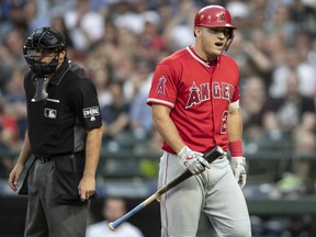 Los Angeles Angels' Mike Trout reacts after striking out looking to Seattle Mariners starting pitcher Marco Gonzales during the fifth inning of a baseball game Thursday, July 5, 2018, in Seattle.