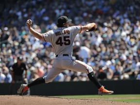 San Francisco Giants starting pitcher Derek Holland throws against the Seattle Mariners during the second inning of a baseball game, Wednesday, July 25, 2018, in Seattle.