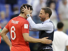 England head coach Gareth Southgate, right, celebrates victory of his team over Sweden with England's Harry Maguire during the quarterfinal match between Sweden and England at the 2018 soccer World Cup in the Samara Arena, in Samara, Russia, Saturday, July 7, 2018.