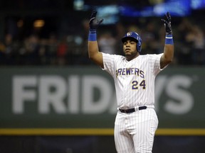 Milwaukee Brewers' Jesus Aguilar reacts after hitting a double during the fifth inning of a baseball game against the Atlanta Braves, Friday, July 6, 2018, in Milwaukee.