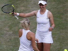 Katerina Siniakova of the Czech Republic, left, and Barbora Krejcíkova of the Czech Republic celebrate defeating Nicole Melichar of the US and Kveta Peschke of the Czech Republic in their women's doubles final match at the Wimbledon Tennis Championships in London, Saturday July 14, 2018.