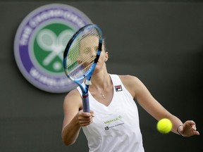 Karolina Pliskova of the Czech Republic prepares to serve to Mihaela Buzarnescu of Romania during their women's singles match on the fifth day at the Wimbledon Tennis Championships in London, Friday July 6, 2018.