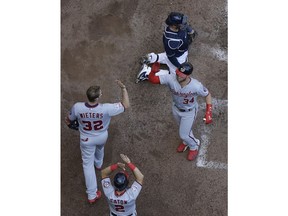 Washington Nationals' Bryce Harper is congratulated after hitting a three-run home run during the fifth inning of a baseball game against the Milwaukee Brewers Wednesday, July 25, 2018, in Milwaukee.