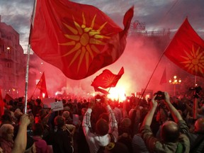 FILE - In this file photo dated Saturday, June 23, 2018, opponents of the deal between Greece and Macedonia, on changing the country's new name to "North Macedonia", outside the parliament in Skopje, Macedonia. The Russian Embassy in Macedonia on Tuesday July 17, 2018, denied allegations from Macedonian Prime Minister Zoran Zaev, that Moscow has been involved in public protests against an agreement with Greece, that would enable the former Yugoslav republic to join NATO.