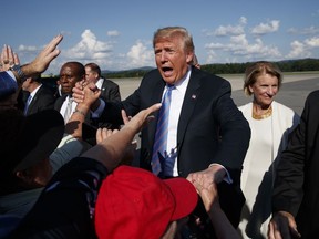 President Donald Trump greets supporters after arriving at the Greenbrier Valley Airport in Lewisburg, W.Va., before attending a "Salute to Service" dinner, Tuesday, July 3, 2018, in White Sulphur Springs, W.Va.