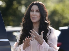 FILE - In this Aug. 21, 2016, file photo, singer and actress Cher stops to talk to media as she leaves a fundraiser for Hillary Clinton at the Pilgrim Monument and Provincetown Museum in Provincetown, Mass. Cher, composer Phillip Glass, country music star Reba McEntire and jazz legend Wayne Shorter have been announced as this year's recipients of the Kennedy Center Honors awards. The recipients will be honored in a special ceremony at Washington's Kennedy Center on Dec. 2.