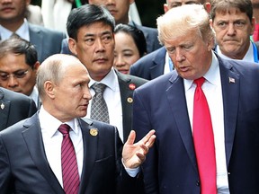 FILE - In this Nov. 11, 2017, file photo, U.S. President Donald Trump, right, and Russia's President Vladimir Putin talk during the family photo session at the APEC Summit in Danang. Trump's persistence in pursuing a bromance with Putin has highlighted a growing disconnect within his administration over Russia policy. While Trump speaks fondly of Putin and a desire for better relations with Moscow, the rest of the executive branch remains highly critical and deeply suspicious of the Russian president and Kremlin intentions