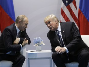 FILE - In this July 7, 2017, file photo, President Donald Trump meets with Russian President Vladimir Putin at the G20 Summit in Hamburg. Trump seems of two minds about nuclear weapons. He has mused about their elimination. But he also has called for a U.S. buildup and bragged about his nuclear "button." How these seemingly competing instincts will play out in his Helsinki talks with Putin on July 16, 2018,  could profoundly affect the direction of U.S. defense policy.