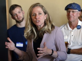 Former CIA officer and Democratic candidate for the 7th district Congressional seat, Abigail Spanberger, center, speaks to supporters at a rally in Richmond, Va., Wednesday, July 18, 2018.  Opposition to President Donald Trump is changing the political map for Democrats who find themselves riding a wave of anti-Trump energy to compete in areas they once left for lost.