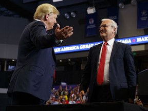 FILE - In this June 27, 2018, file photo President Donald Trump hugs Senate candidate Rep. Kevin Cramer, R-N.D., during a campaign rally in Fargo, N.D. The conservative Koch brothers' network declared July 30, that it will not help elect Cramer, the Republican Senate candidate in North Dakota, turning its back on the GOP in a marquee election -- at least for now -- after determining that the Republican challenger is no better than the Democratic incumbent Heidi Heitkamp.