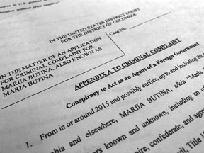 Court papers unsealed Monday, July 16, 2018, photographed in Washington, shows part of the criminal complaint against Maria Butina. She was arrested July 15, on a charge of conspiracy to act as an unregistered agent of the Russian government.