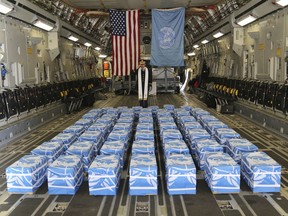 United Nations Command Chaplain U.S. Army Col. Sam Lee performs a blessing of sacrifice and remembrance on the 55 cases of remains believed to be U.S. servicemen killed during the Korean War and returned by North Korea at Osan Air Base in Pyeongtaek, South Korea, Friday, July 27, 2018.