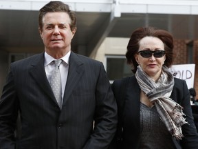 FILE - In this March 8, 2018, file photo, Paul Manafort, left, President Donald Trump's former campaign chairman, walks with this wife Kathleen Manafort, as they arrive at the Alexandria Federal Courthouse in Alexandria, Va. The special counsel's office says it plans to call 35 witnesses in the upcoming trial of Manafort.