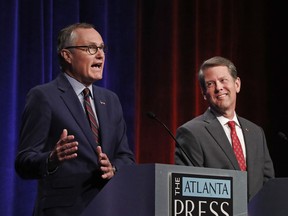 In this July 12, 2018, photo, Republican candidates for Georgia Governor Georgia Lt. Gov. Casey Cagle, left, and Secretary of State Brian Kemp speak during an Atlanta Press Club debate at Georgia Public Television  in Atlanta. The two will face each other July 24 in a runoff election for the Republican nomination.